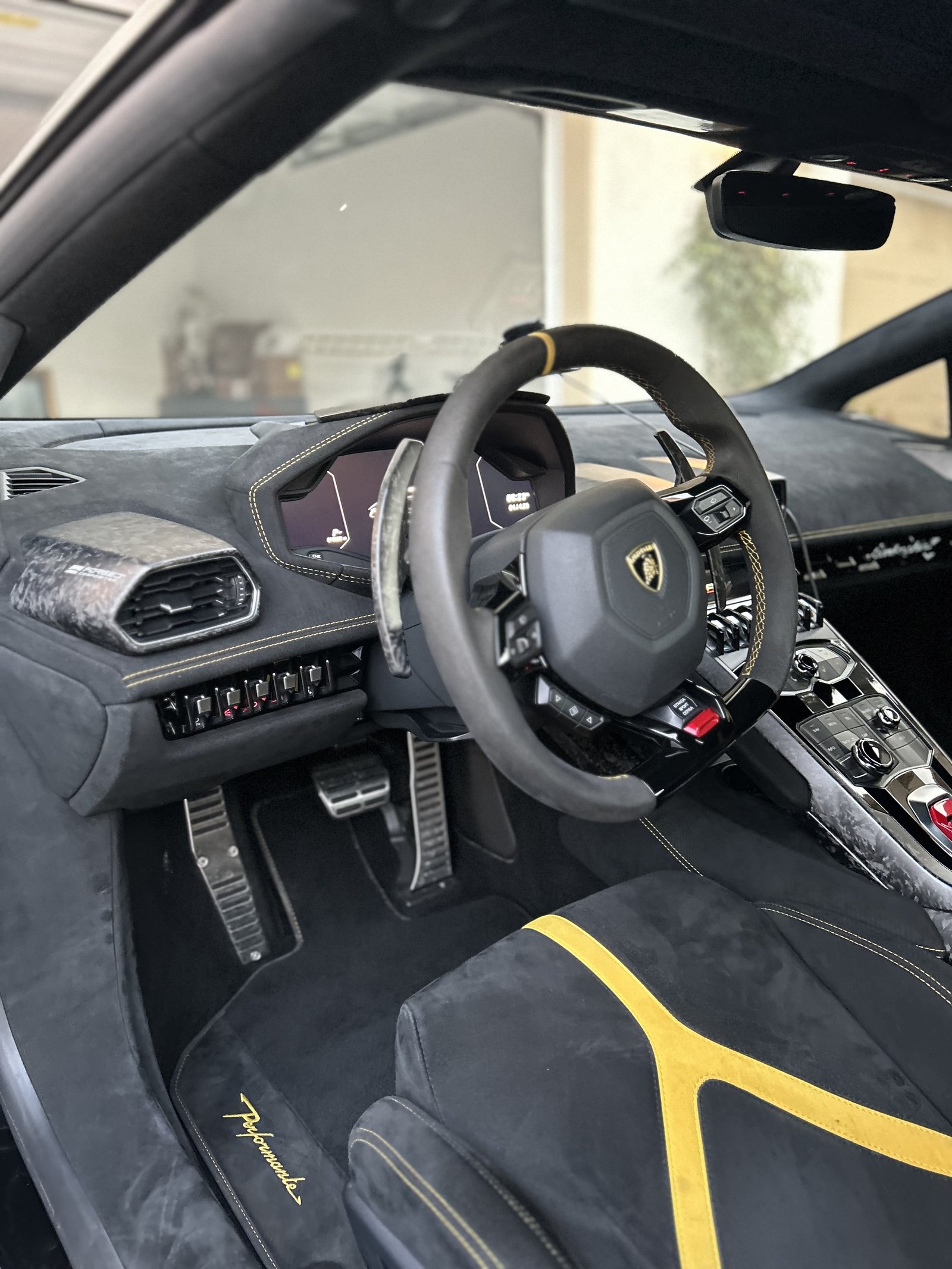 Interior steam cleaning on a black Lamborghini performance model
